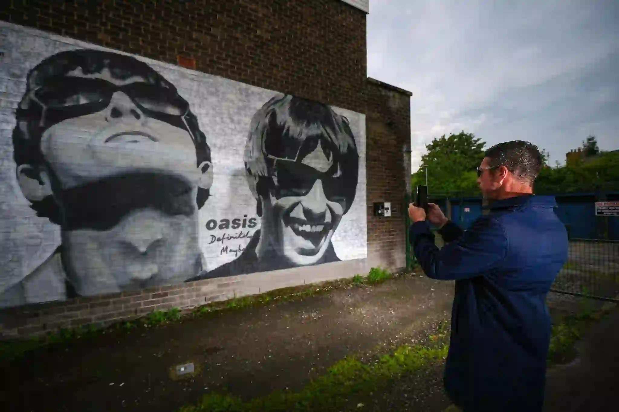 “Oasis band members Liam and Noel Gallagher during a live performance”