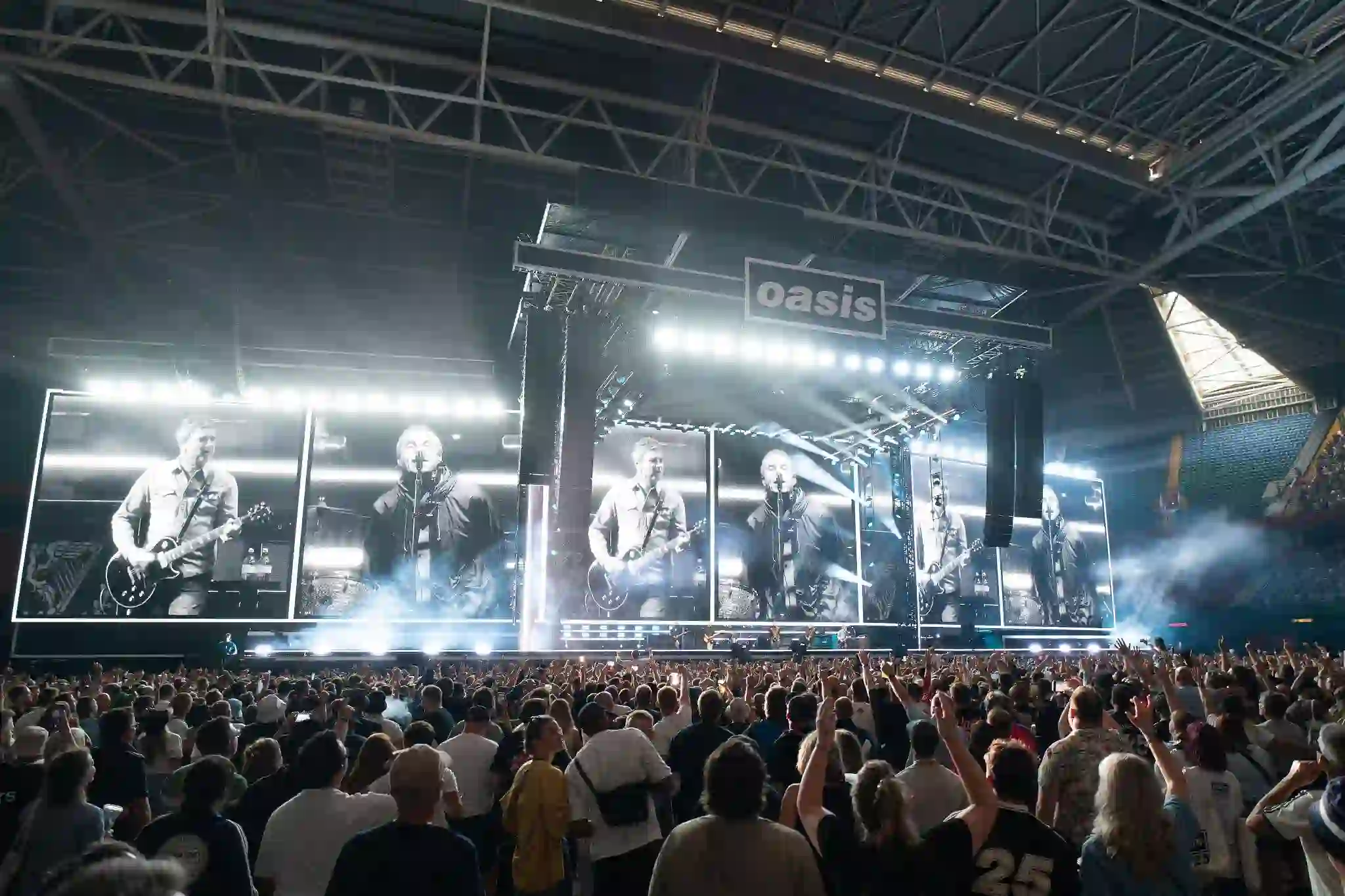 “Oasis band members Liam and Noel Gallagher during a live performance”